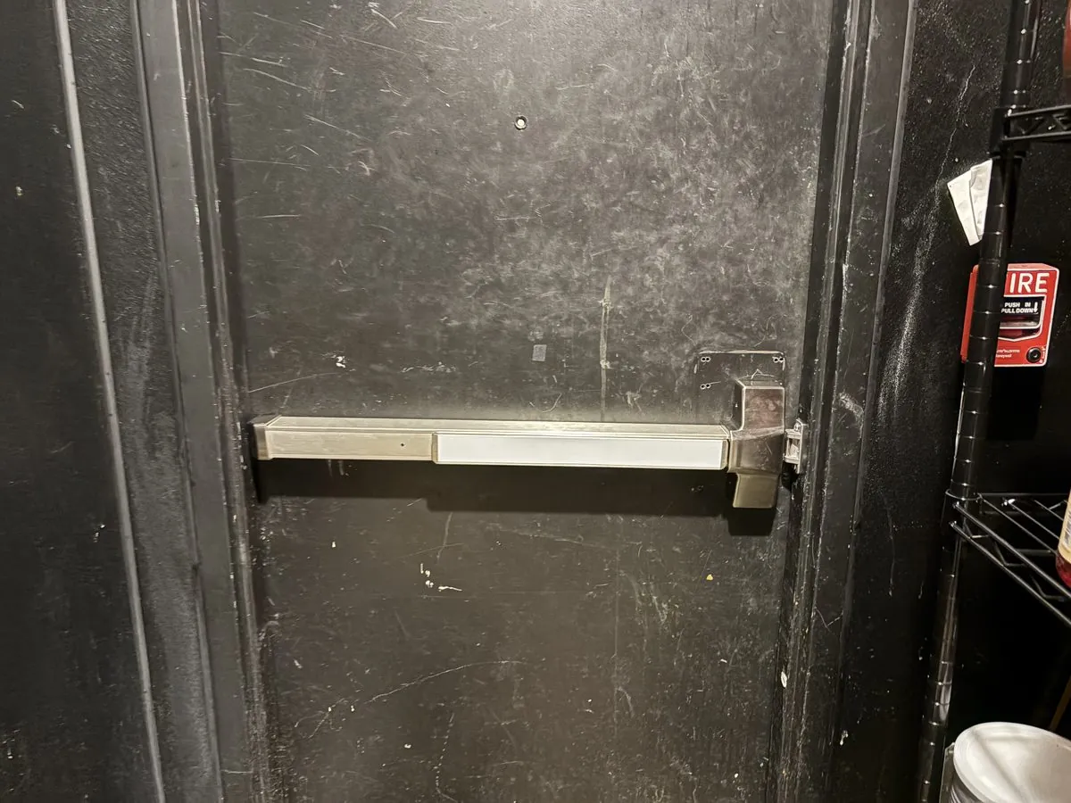 Commercial panic bar installed on a fire-rated exit door