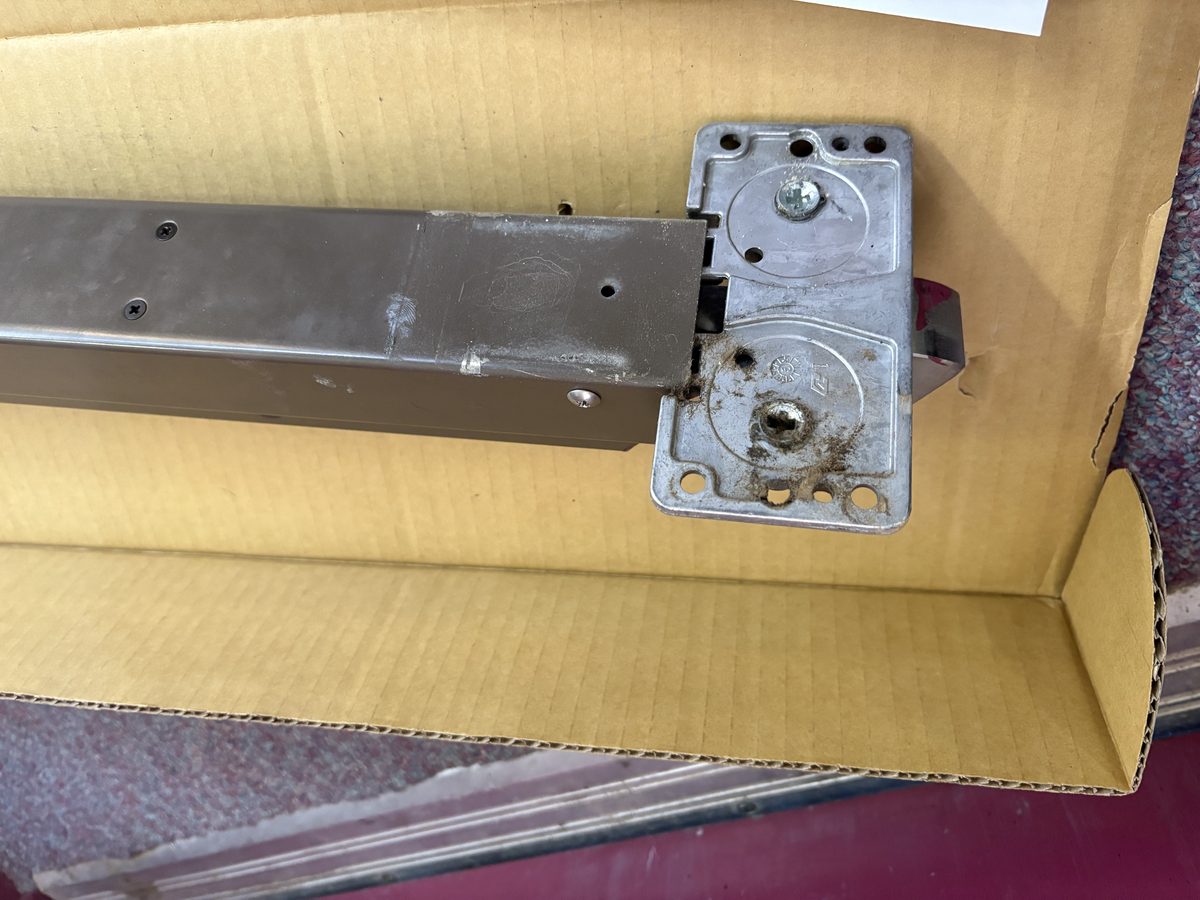 Door closer arm replacement on a commercial door