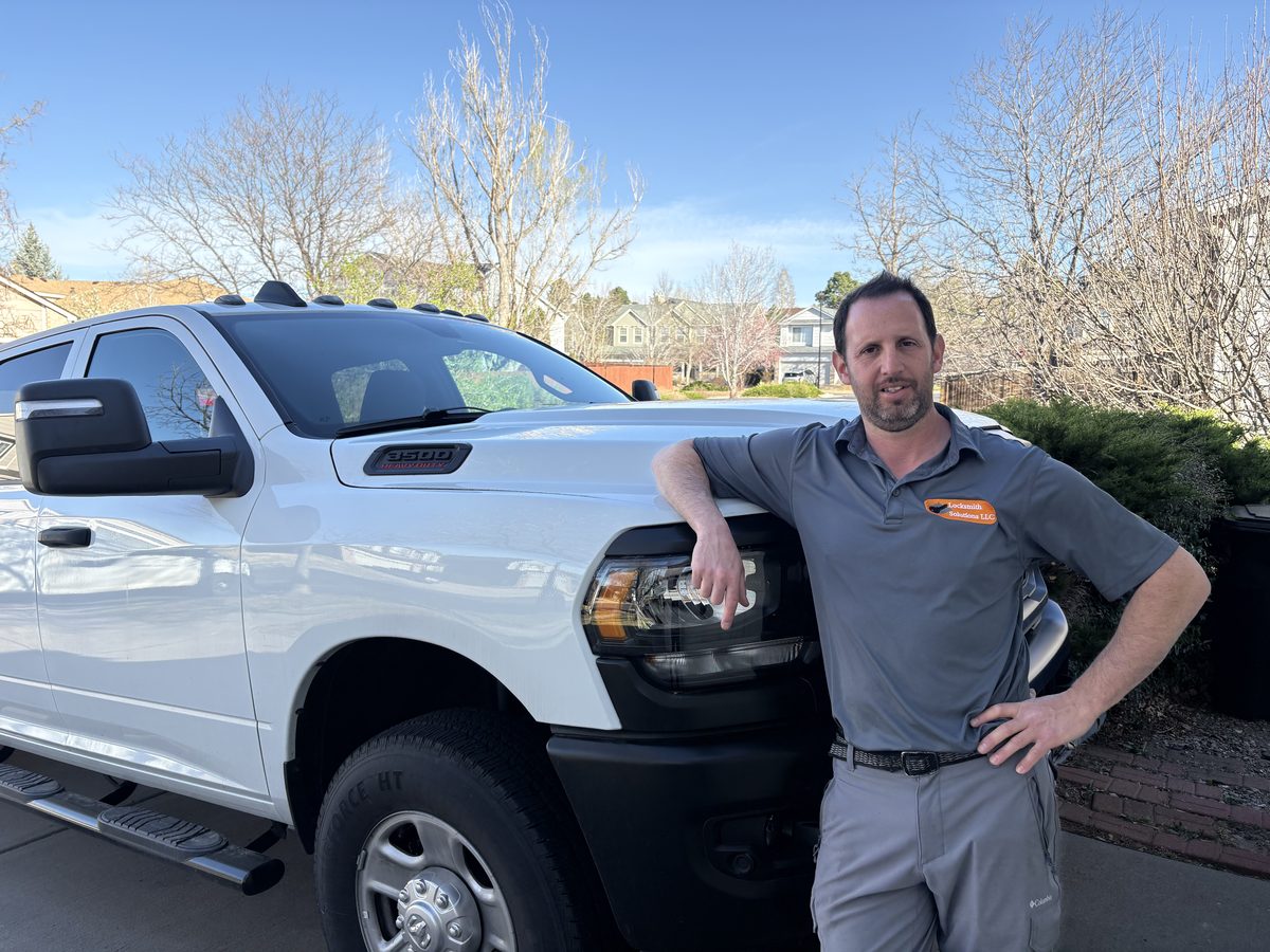 Eyal standing beside the Locksmith Solutions mobile work truck before a service call in Colorado Springs