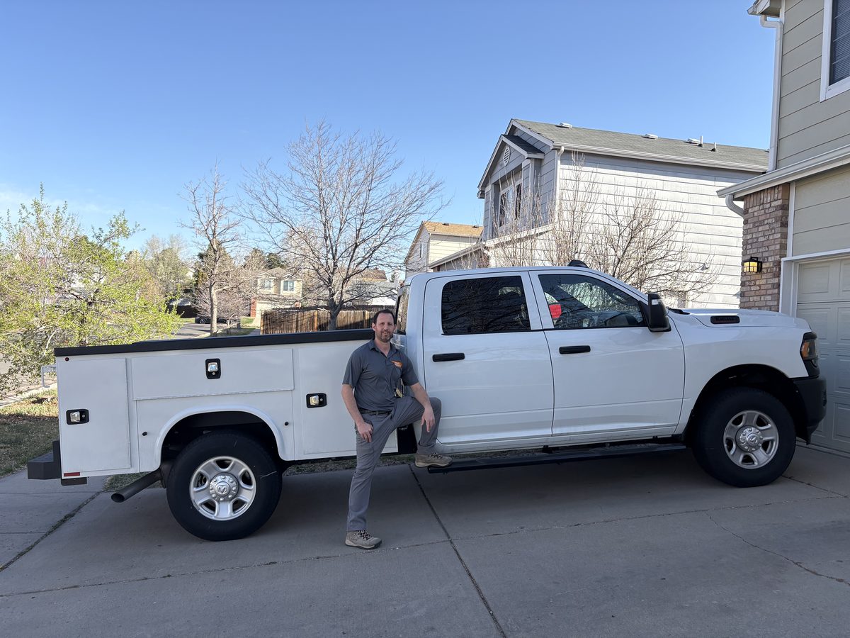 Eyal standing beside the Locksmith Solutions mobile work truck in Colorado Springs