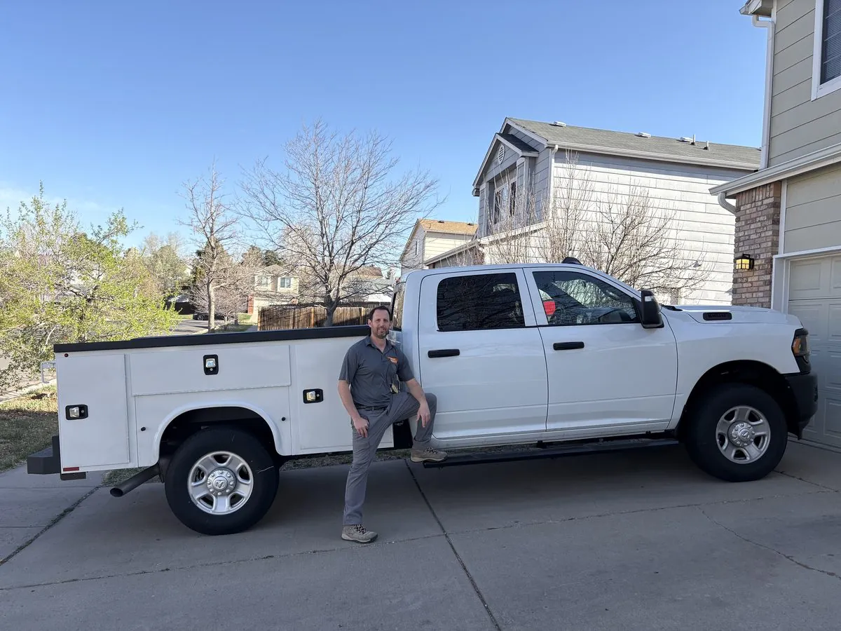 Eyal standing beside the Locksmith Solutions mobile work truck in Colorado Springs