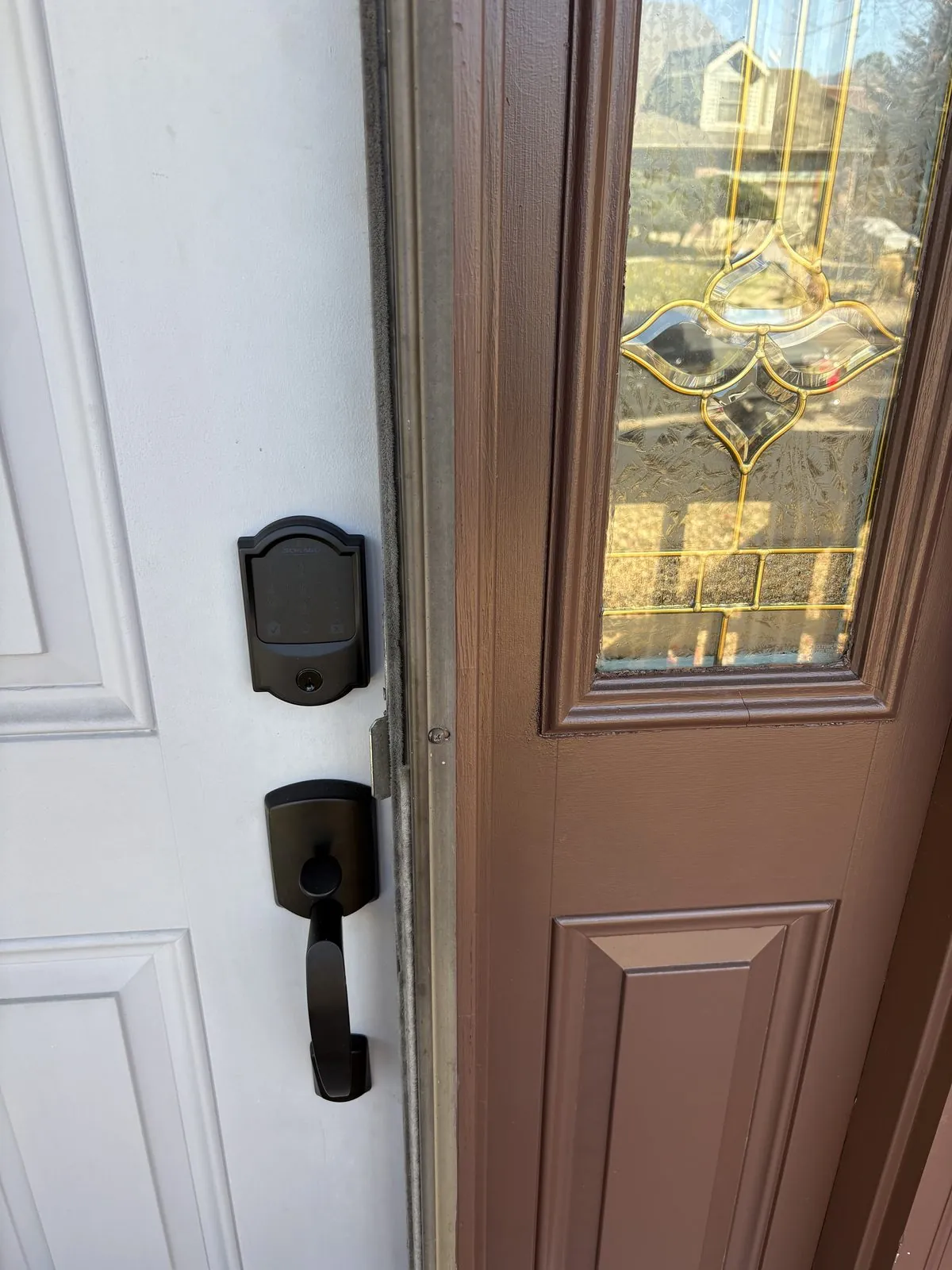 Residential deadbolt and handleset on a Colorado Springs front door, illustrating the choice between lock rekey and lock replacement
